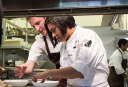 Maree gets tips on plating from Chef Daniel Corey.